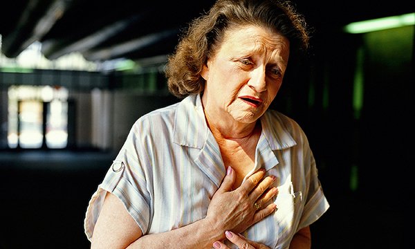 woman indicating chest pain