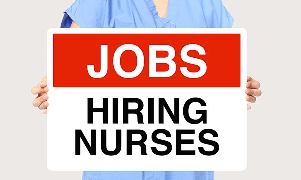 Nurses holds 'hiring' sign