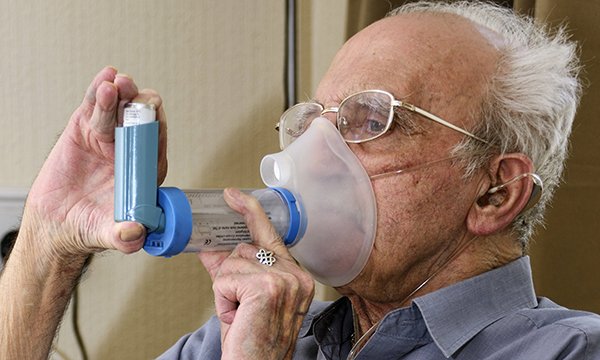 Man uses an inhaler
