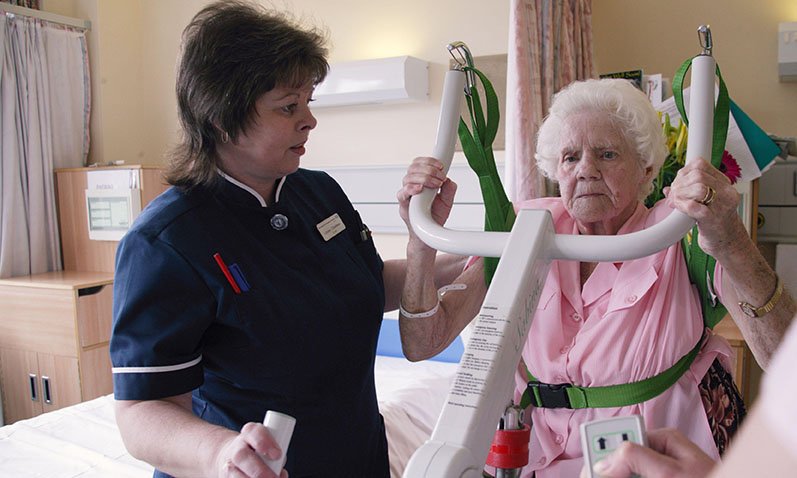 Nurse assisting older patient