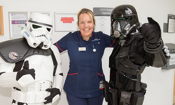Nurse flanked by people in Star Wars outfits
