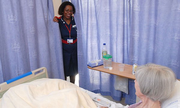 nurse checks on patient