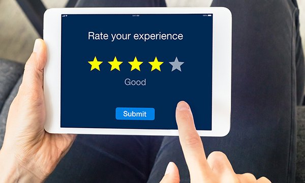 A tablet screen with 'Rate your experience' and a survey on it