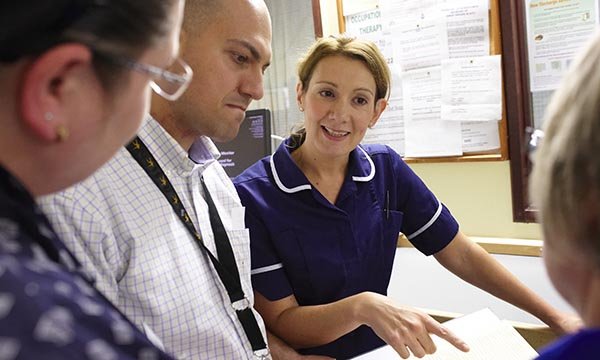 nurse talks to team colleagues