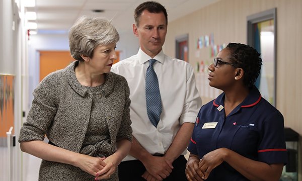 Prime minister Theresa May and health secretary Jeremy Hunt at a hospital with a nurse