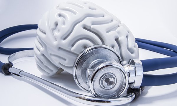 Model of a brain next to a stethoscope