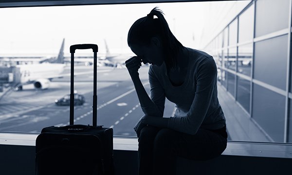 woman looks dejected at airport