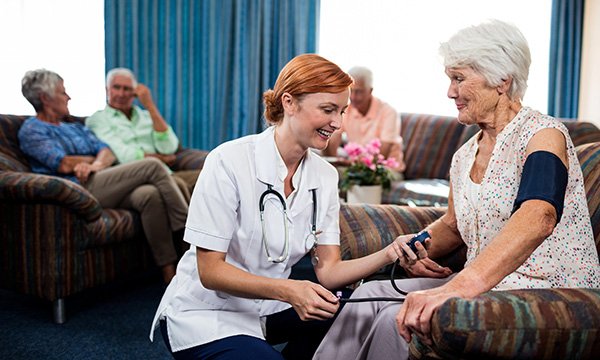 Community nurse visiting a female resident in a care home