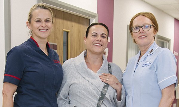 Picture shows ward manager Donna St John (left) and staff nurse Pip Page-Davies (right) with Hazel Carter, a patient who uses one of the drainage bag covers made by Ms Page-Davies and other nurses.