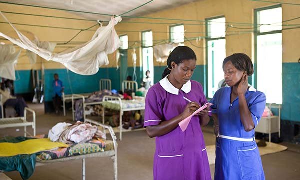 Nurses confer in a hospital ward in Uganda