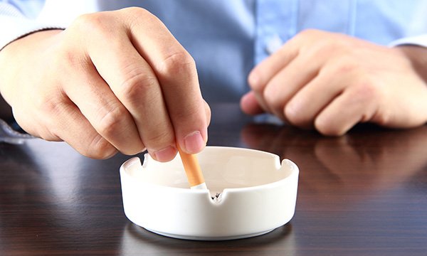 Picture shows a cigarette being stubbed out. Cigarette smoking in England fell by a quarter in 2011-18, pointing to the success of antismoking measures, researchers say