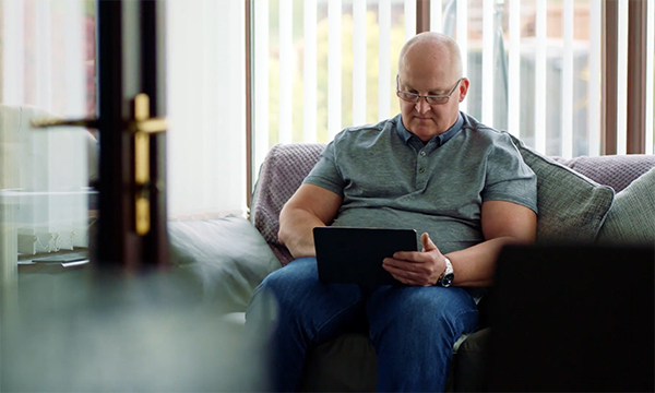 Picture shows an older man checking the results of his PSA test online as part of the supported self-management programme. New care pathways are easing the strain on prostate cancer services and could be applicable to other types of cancer.
