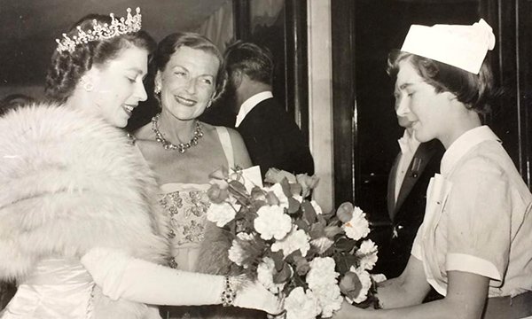 Jean Higgins presents a bouquet to the then Princess Elizabeth, now the Queen at a film premiere 