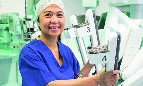 Picture shows theatre nurse Marie Taniacao with the da Vinci Xi robotic surgical system. Her course at the Royal Marsden NHS Foundation Trust will give her the skills to assist surgeons during robotic operations.