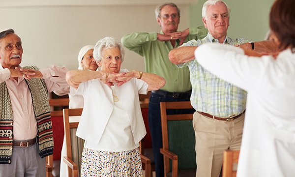 Picture shows a group of older people doing stretch exercises. Prevention of health problems among older people should be a cornerstone of geriatric medicine, and nurses have an important role to play.