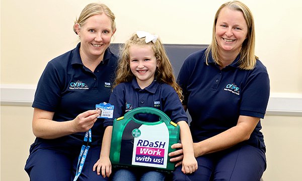 Picture of Nahla Walker (centre), with nurses Helen Drury (left) and Joanne Leivesley. When Nahla, aged six, told them she wanted to be a nurse, they ordered a special outfit for her with the name badge ‘Nurse in training’.