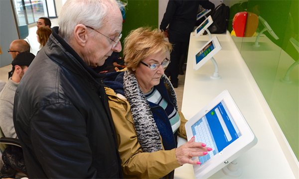 Patients checking in using the eTriage tablet