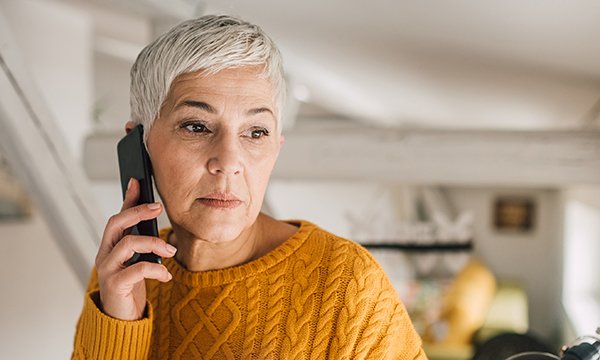 A woman holding a phone. Many woman experiencing breast cancer fear they are missing life extending treatment. Picture: iStock