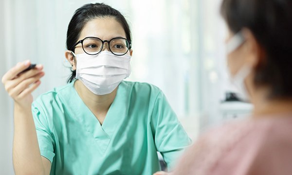 Nurse and patient wearing masks