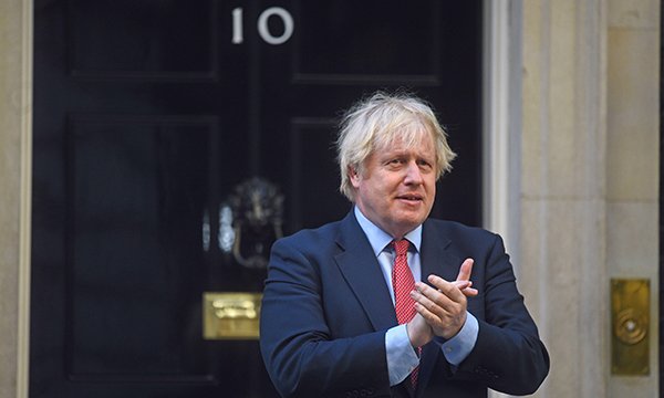 Prime minister Boris Johnson clapping outside No 10 Downing Street. Picture: Alamy