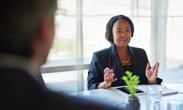 Black female talking in a boardroom