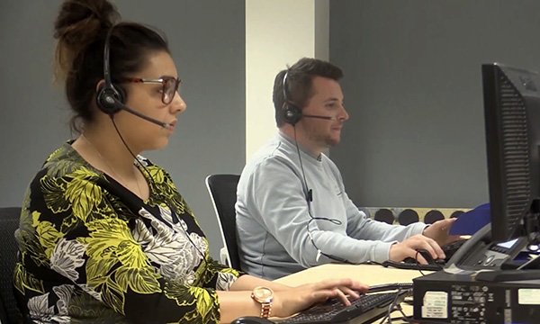 Picture shows peple weating headsets taking calls at the Greater Manchester Resilience Hub, set up after the 2017 attack