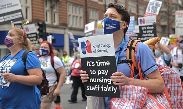 A nurse holds a placard during a demonstration in London in July 