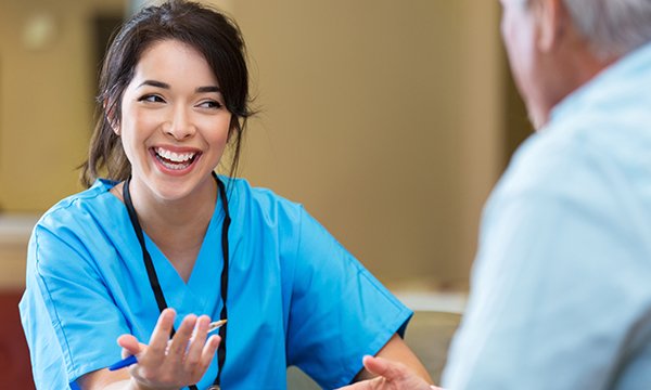 Picture of a young female nurse smiling during a conversation