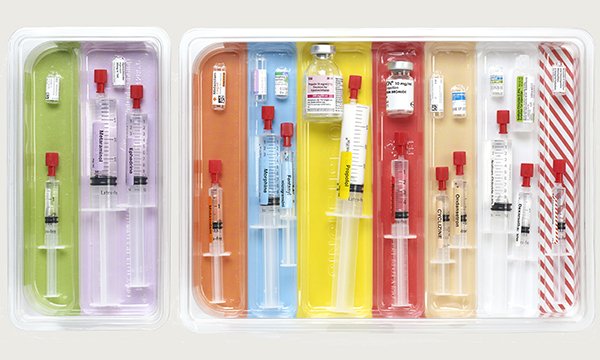 Multicoloured trays holding syringes used in anaethesia