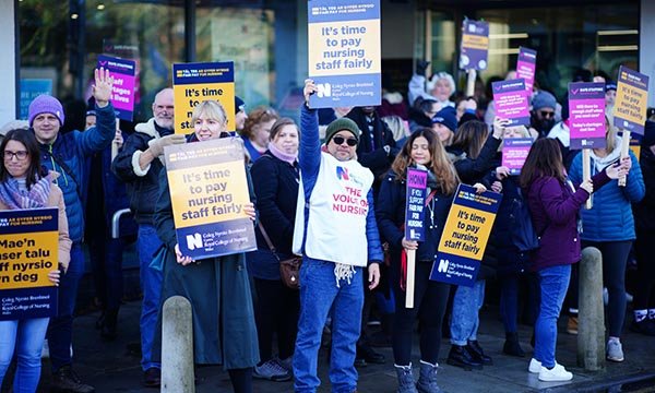 RCN members hold placards as they stage picket near Cardiff University Hospital during pay strike in December 2022