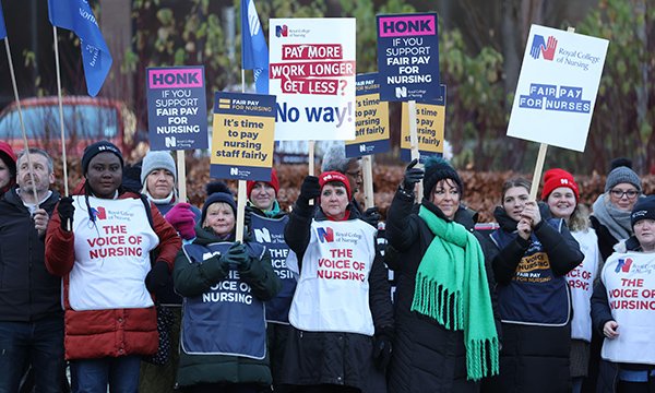 Striking nurses hold placards on RCN picket line as college members vote to reject government's NHS pay offer in England