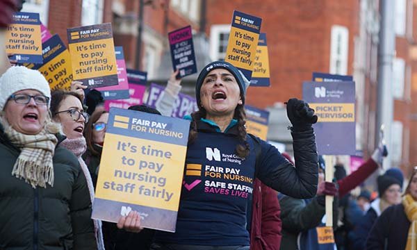Striking nurses on NHS picket lines in Devember 2022 call for better pay 