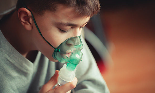 Boy uses nebuliser