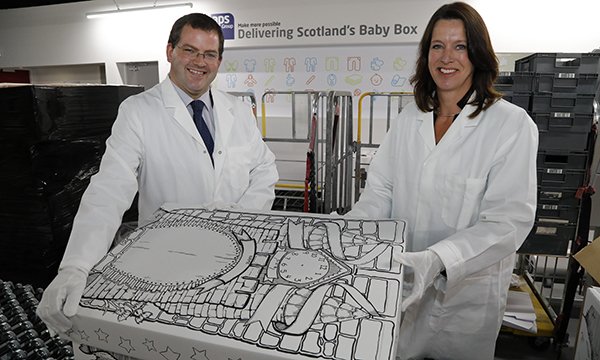 woman and man hold baby box