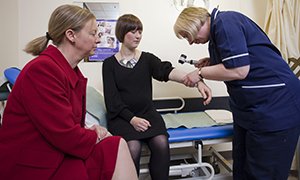 Shona Robison (left) visits a skin cancer clinic at NHS Lothian 