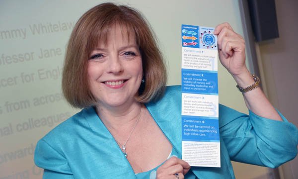 Jane Cummings holding up a 10 commitments card