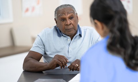 An older black man in a sickle cell disease consultation with a primary care nurse
