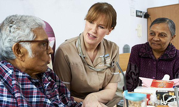 nursing associate talks to patient and relative
