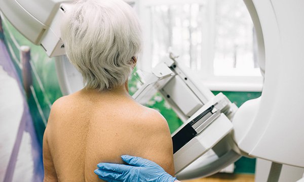 Picture shows an older woman having a mammography scan. Alcohol use is estimated to be responsible for 5% to 11% of breast cancer cases and current evidence suggests that it is a risk factor for all age groups.