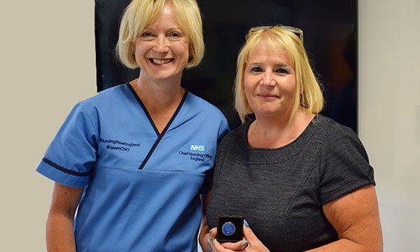 Mental health lead Gill Drummond (right) receives the CNO Silver Award for Excellence in Nursing from chief nursing officer for England Ruth May