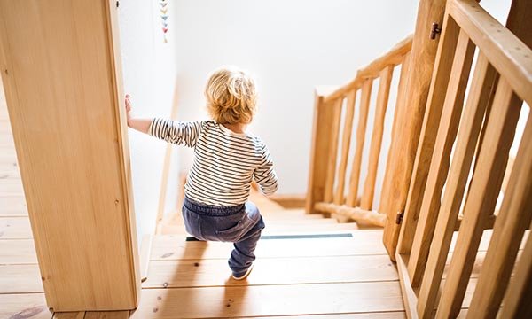 Child at top of stairs may fall