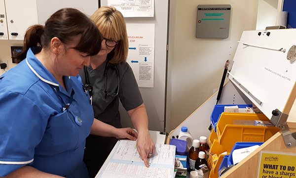 Emma Robinson, left, a nurse on the out of practice programme, and advanced clinical practitioner Helen Lushpenko-Brown, checking patient medications