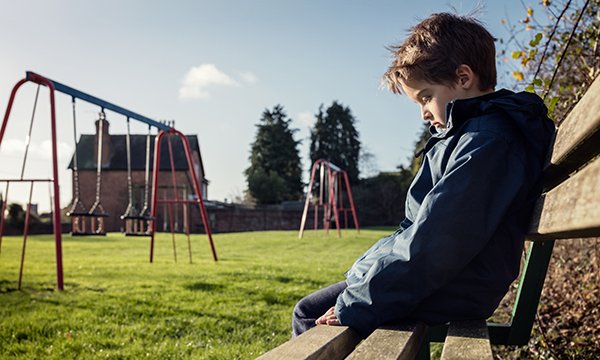 Picture of a child alone on a park bench