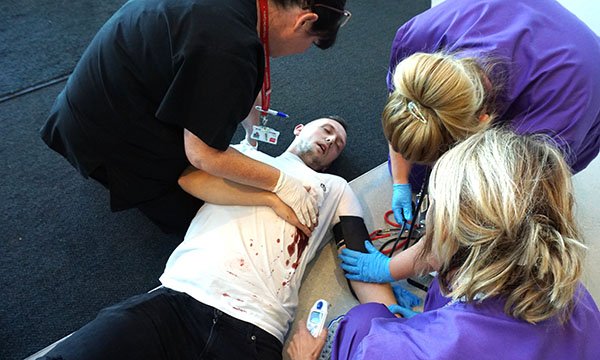 image of nursing students in a emergency care simulation scenario