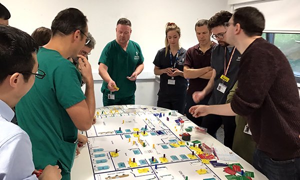 Picture of healthcare professionals taking part in The Floor game, which simulates the challenges of an emergency department and is helping nurses to develop clinical leadership skills.