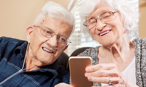 Two older people going through a video consultation on a smart phone. Consultations can now take place via video call over the internet. Picture: iStock