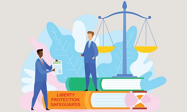 Image of two human figures, one on huge book titled Liberty Protection Safeguards, against backdrop of scales of justice. Article explains how new Liberty Protection Safeguards for people lacking mental capacity could affect learning disability nurses.
