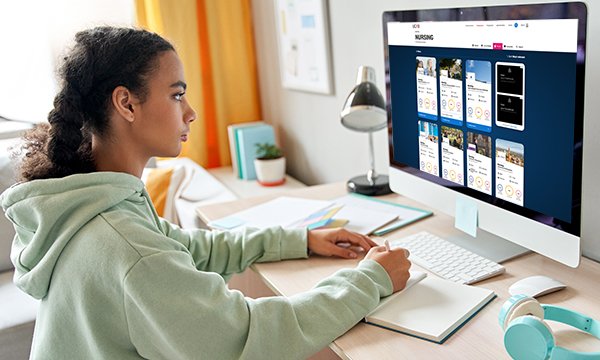Young woman looks at nursing programmes page of UCAS website