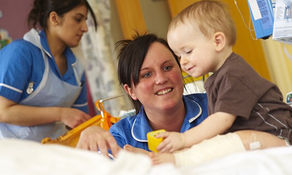 A children’s nurse interacts with a young patient, displaying that different nursing fields require specific skill sets