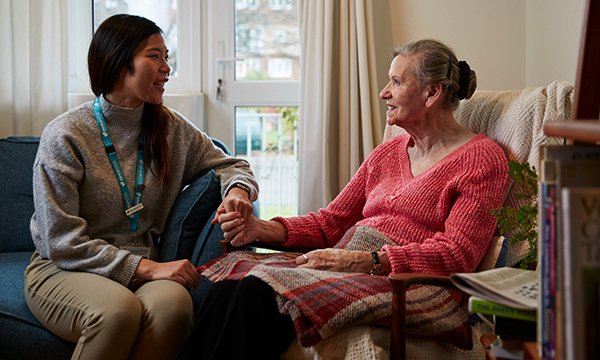 An Admiral Nurse talking with an older woman affected by dementia